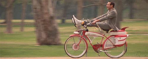 peewee herman rides a bike